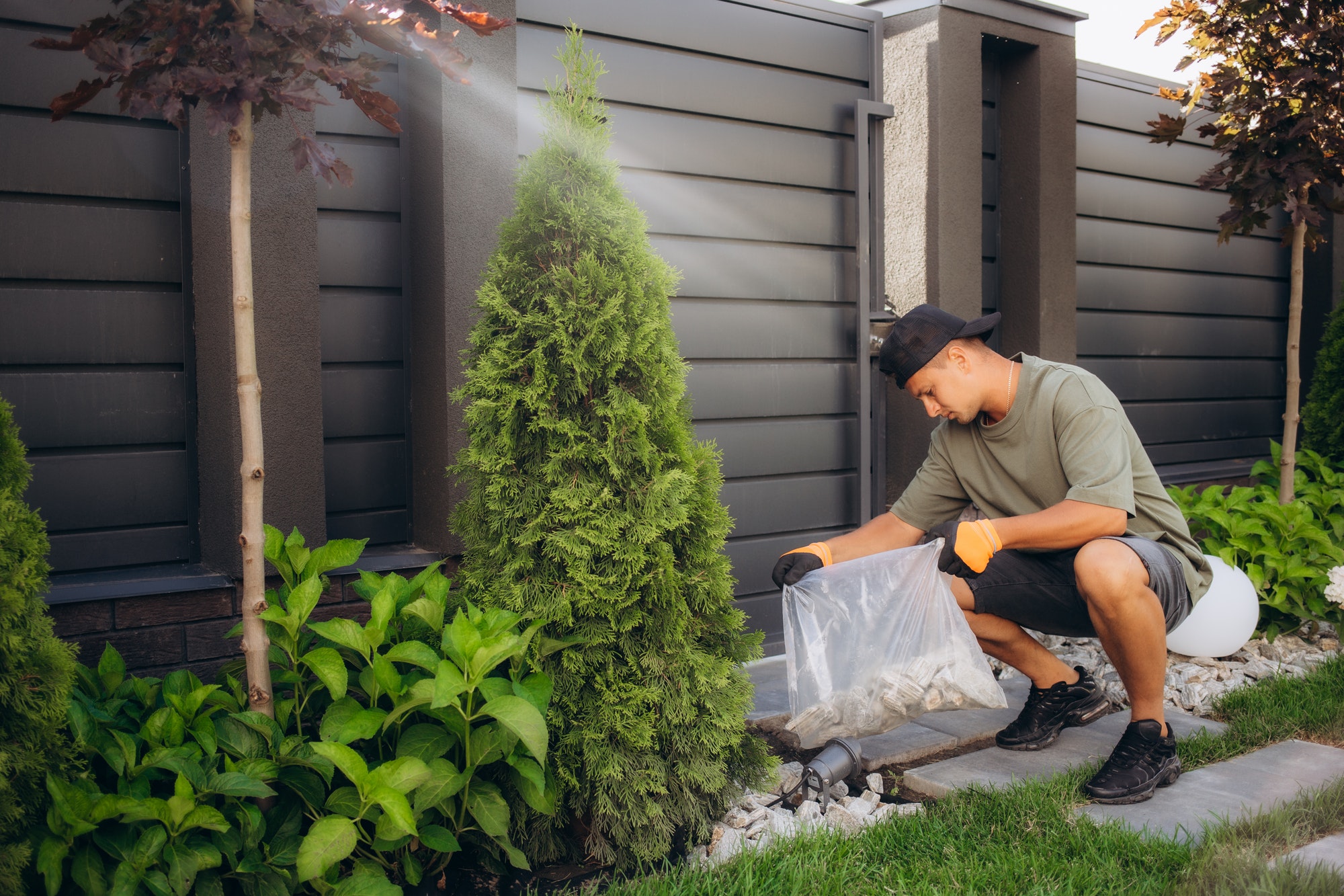 The worker places a stone carpet with resin. Shallow DOF